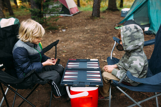 Boys Playing Game in the Forest while Camping