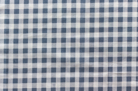 Wrinkled navy and white gingham check fabric texture