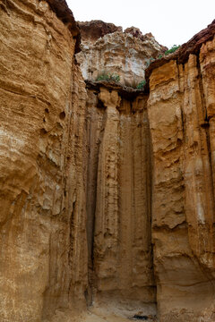 looking up at a rocky cliff face