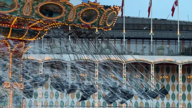 Close up of chair swing carousel in motion at Tivoli Gardens, Copenhagen city