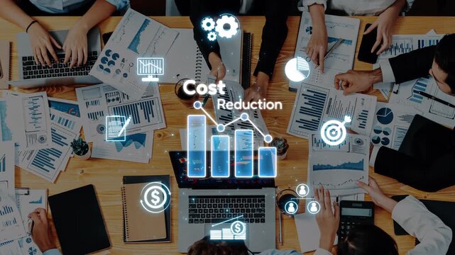 A dynamic business meeting focusing on cost reduction strategies, showcasing team collaboration with charts and digital icons in a modern office environment. Raster