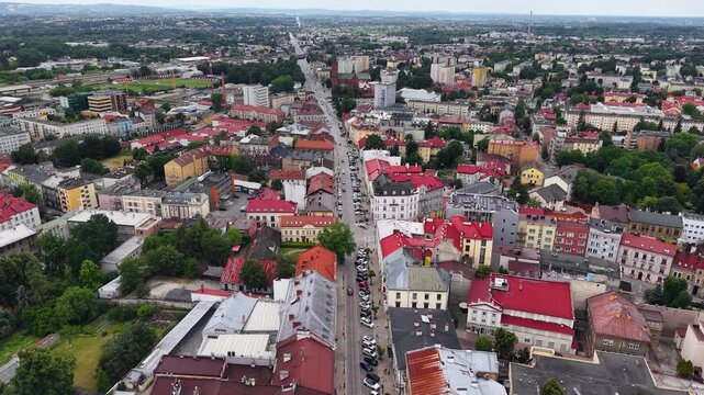 Flight over Tarnow cityscape with traditional red roofs and streets, Poland