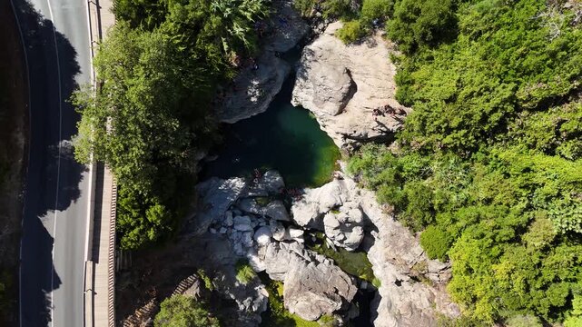 Top down aerial view of natural rock pool in river gorge, Benahavis, Spain