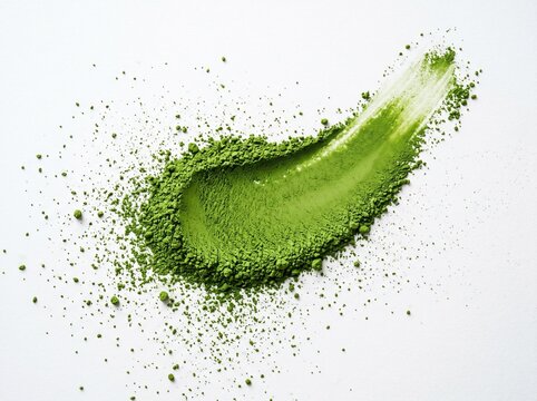 A striking visual of bright green matcha powder and a creamy swatch, artfully arranged on a clean white surface, highlighting its texture and rich color.