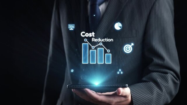 A businessman in a suit presents a glowing digital screen with cost reduction graphs and financial icons, showcasing data visualization in a modern office context. Qubit