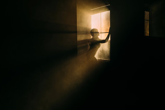 silhoutte of a woman by a window