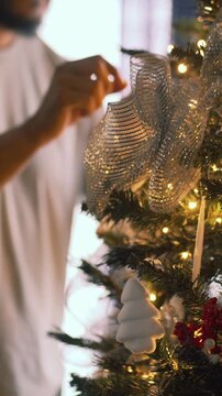 Person decorating a festive christmas tree