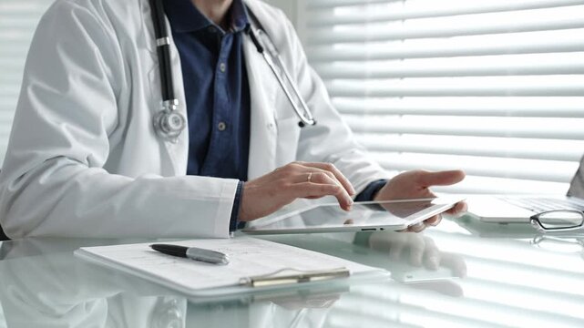 Doctor taking notes on a clipboard and holding a digital tablet, combining traditional paperwork with modern technology in healthcare for patient record management and medical consultation