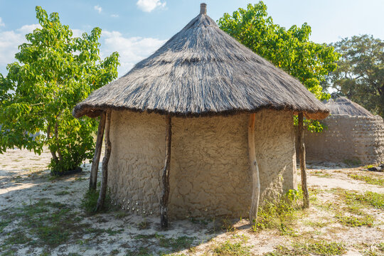 Closeup of traditional round mud hut with thatched roof of natives of Botswana, Africa