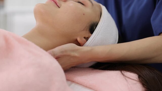 Relaxing neck and jawline massage treatment at a wellness spa.