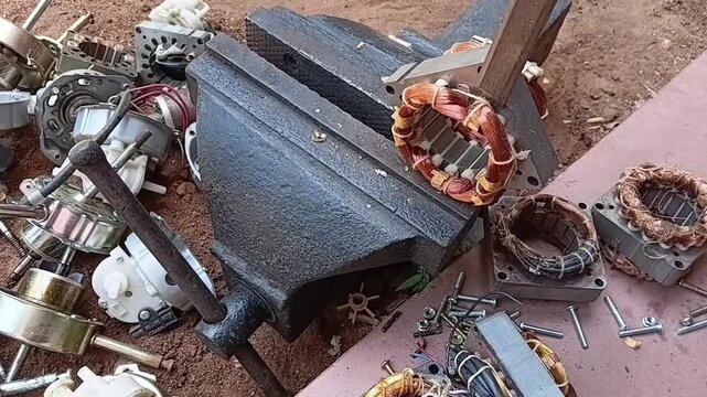 Manual Stator Coil Cutting Process Using Hammer and Chisel. Breaking Copper Winding of Scrap Electric Motor in Workshop for Copper Extraction