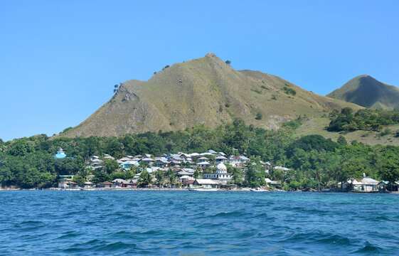 A beautiful view of a remote settlement amidst clear waters on Nuca Molas Island, West Manggarai, Flores, Indonesia