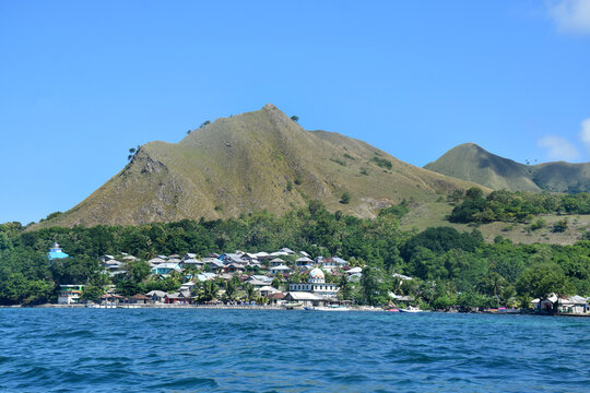A beautiful view of a remote settlement amidst clear waters on Nuca Molas Island, West Manggarai, Flores, Indonesia