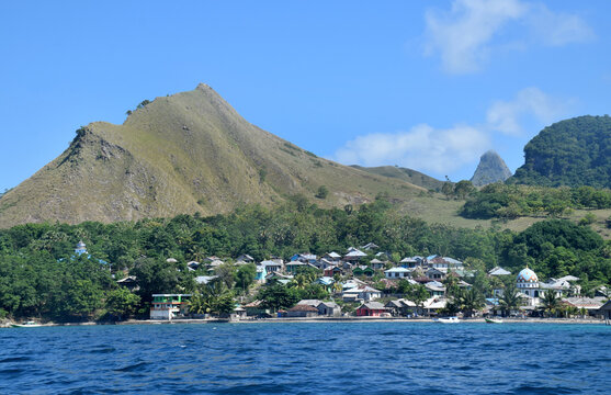 A beautiful view of a remote settlement amidst clear waters on Nuca Molas Island, West Manggarai, Flores, Indonesia
