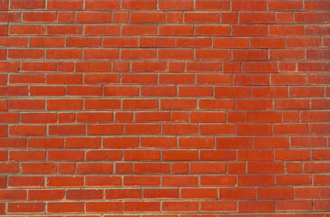 Fototapeta premium Orange brick wall texture background. Background for text. Exterior architecture concept. Dirty orange brick wall abstract background. Background for construction.