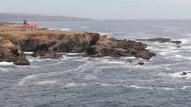 View the Point Cabrillo Lighthouse and surrounding coast near Mendocino and Fort Bragg in California beside the Pacific Ocean.