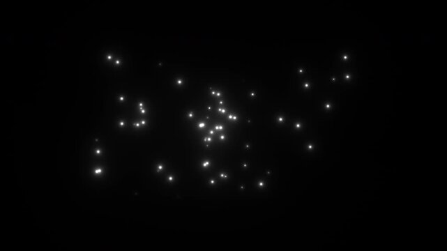 Glowing particles move in dark space creating a dynamic scene