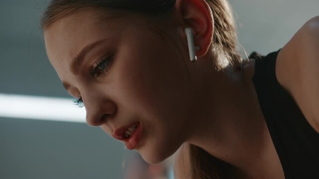 Young Athlete Trying to Suppress Adrenaline Rush, Aggressive Emotions After Failed Sports Performance. Girl Using Music Safe Space to Transform Panic and Anger in Motivation Before Heading Back Out.