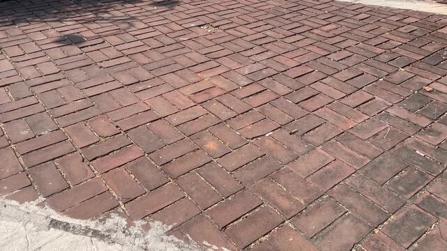 Rustic red clay brick pavers texture on outdoor driveway pattern