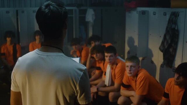 Charismatic Football Coach in White T Shirt Confidently Using Dynamic Hand Gestures and Drawn Diagram to Explain Tactical Scheme to Attentive Team. Sport Leadership, Important Role of Strict Mentor.