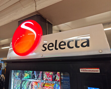 Stockholm, Sweden-Nov.28th 2025: Selecta brand logo and sign on vending machine.