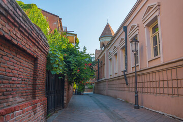 Fototapeta premium Picturesque empty street in old Tbilisi with traditional architecture and sky copy space