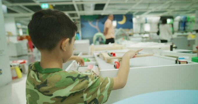 Little school boy enjoy wooden block building toy education concept