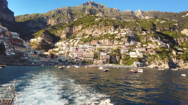 Beautiful coastal village of positano seen from departing ferry boat during summer vacation trip.