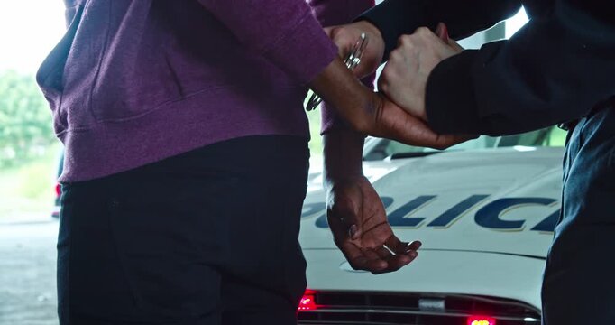 The police have made an arrest during a scene involving a handcuffed individual who was detained