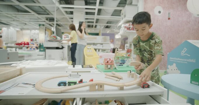Little school boy enjoy wooden block building toy education concept