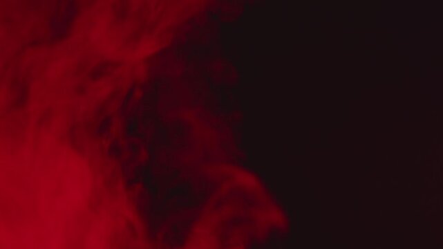 Red Smoke Pulsing Twice from Bottom, Stopping and Rising Again on Black Background
