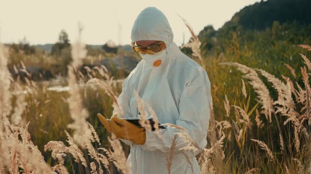 A scientist dressed in protective gear is actively conducting essential field research