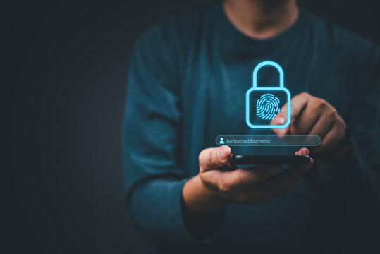 Close up of male holding mobile phone with virtual digital padlock and fingerprint scanner interface. Modern technology concept emphasizing safe data protection, privacy, and identity verification.