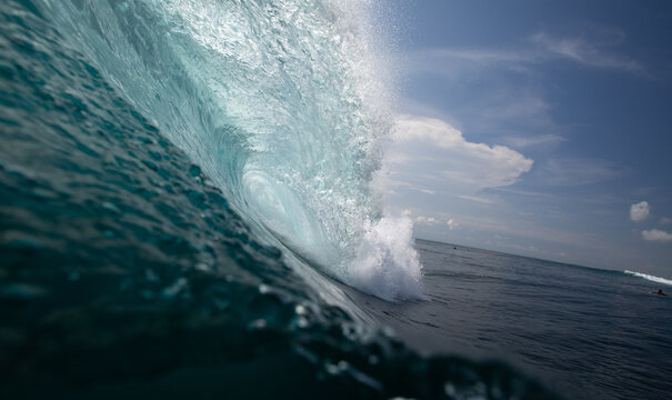 Massive Turquoise Ocean Wave Curling Dynamically Against Clear S