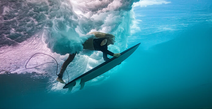 Underwater Action Shot of Blonde Woman Surfing Under Wave