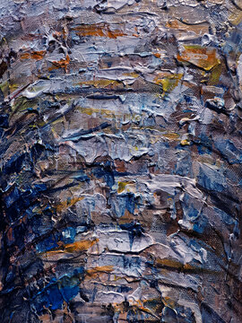 Vibrant messy artist palette covered in glossy paint, scattered brushes and tubes, dried paint