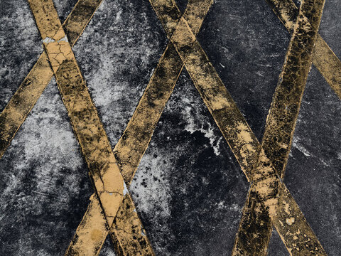 Navy textured surface crossed by gold diagonal lines, grainy indigo ground with speckled paint.