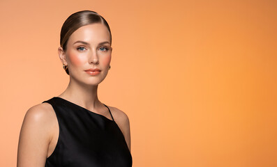 Obraz premium Beauty portrait of woman with sleek hair on orange background