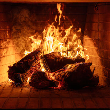 Fireplace burning wood logs. Cozy warm home in winter, Christmas holiday bonfire. Fire flames