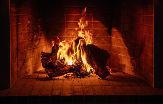 Fireplace burning wood logs. Cozy warm home in winter, Christmas holiday bonfire. Fire flames