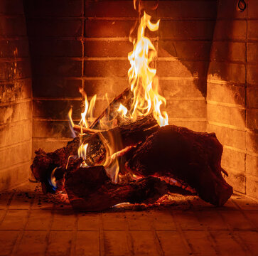 Fireplace burning wood logs. Cozy warm home in winter, Christmas holiday bonfire. Fire flames