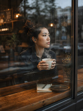 Woman Enjoying Coffee on a Rainy Day