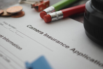 Camera insurance application form on a table