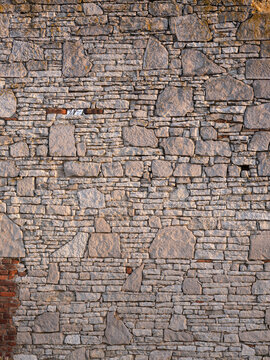 Old medieval castle wall build of irregular stones