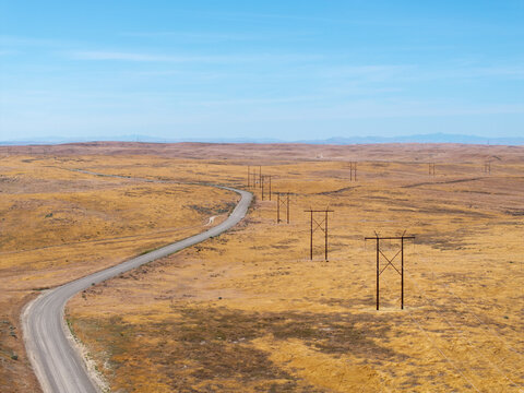 Vast grasslands stretch under a clear blue sky