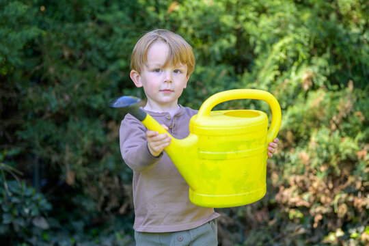 Toddler Holding Yellow Watering Can