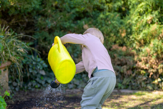 Toddler Watering Garden With Enthusiasm