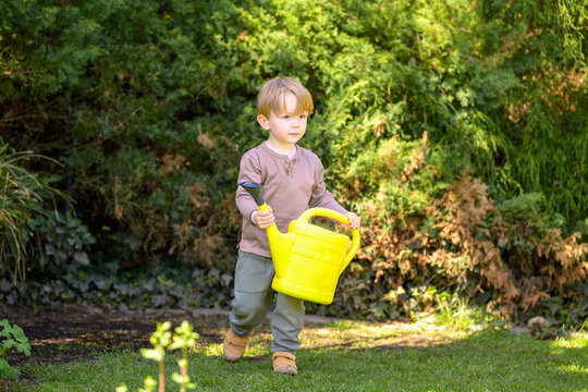 Toddler Carrying Yellow Watering Can