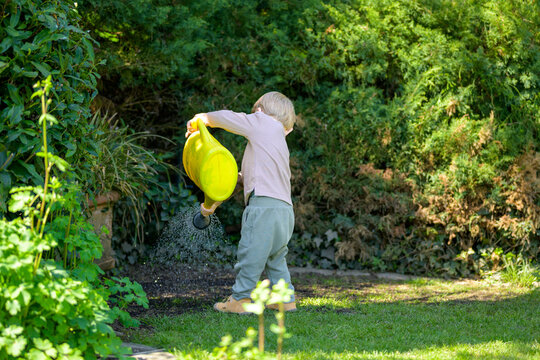 Toddler Watering Garden With Can