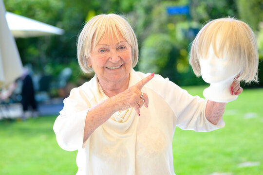 Senior Woman Presenting Blonde Wig